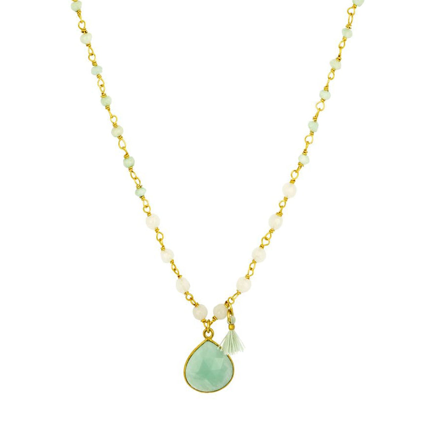 Necklace with a green teardrop pendant on a gold chain against a white background
